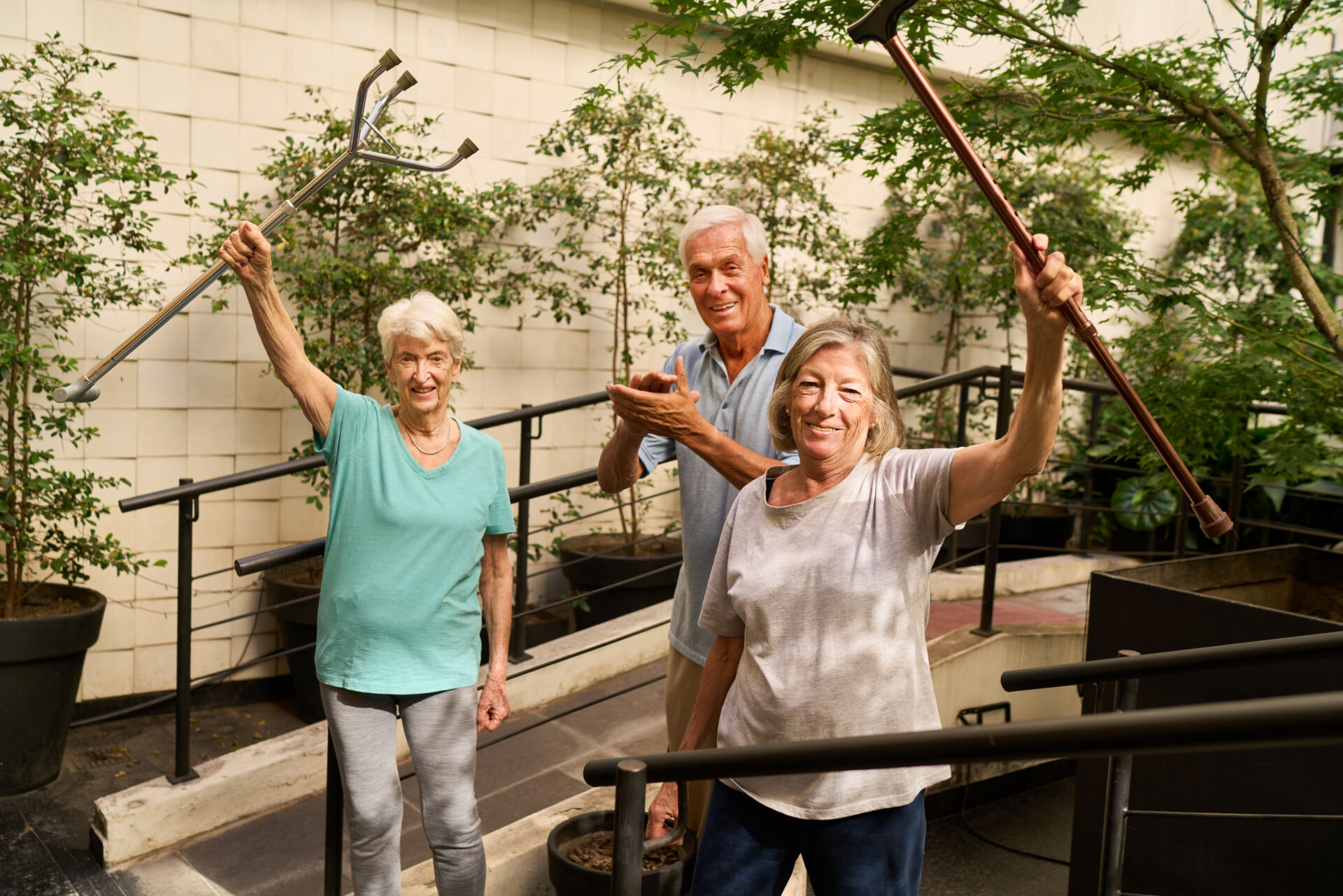 Energetic seniors gardening together at a rehabilitation facility courtyard garden